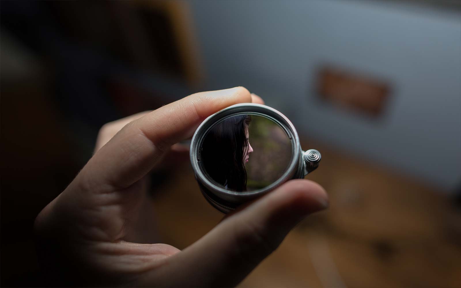 Looking through a lens at a woman